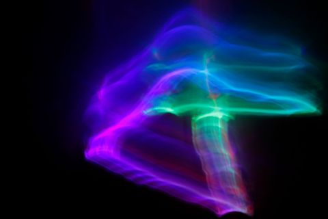 Vibrant neon light streaks on dark background