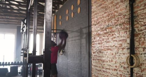 Dynamic medicine ball workout in industrial gym setup