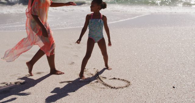 Mother and Daughter Enjoying a Day at the Beach - Download Free Stock Images Pikwizard.com