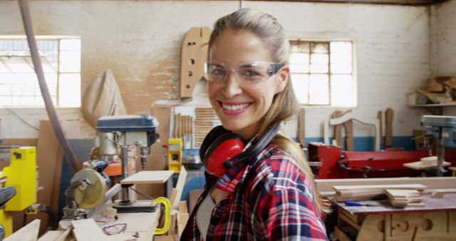 Female Carpenter Smiling and Standing in Workshop with Tools - Download Free Stock Images Pikwizard.com