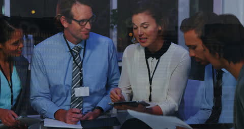 Diverse Business Team Analyzing Data with Technology in Modern Office