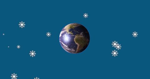 Earth Surrounded by Falling Snowflakes on Blue Background