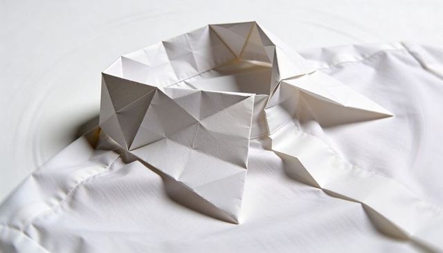 Origami paper collar geometric triangular folds on white dress shirt minimalist concept