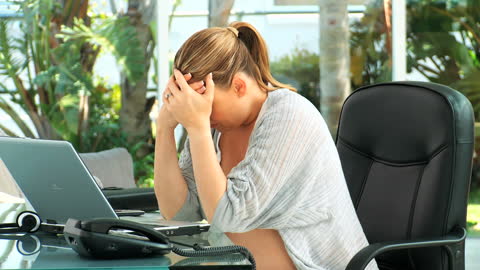 Pregnant Woman Experiencing Back Pain While Working Remotely