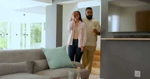 Joyful Couple Celebrating Anniversary with Gift Exchange at Home