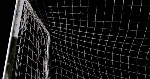 White Soccer Goalpost with Net Against Night Sky