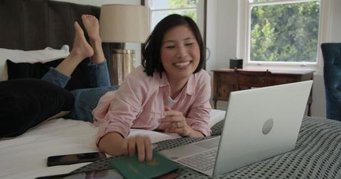 Smiling Woman Online Shopping with Laptop and Card at Home