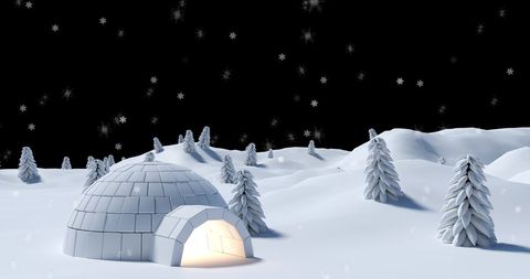 Winter landscape with illuminated igloo and falling snow
