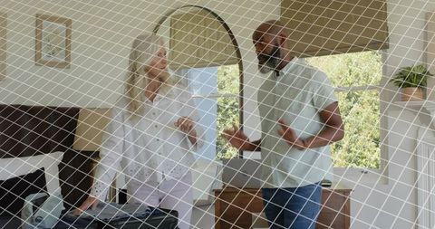 Couple packing suitcase in bright bedroom preparing weekend getaway and discussing outfits