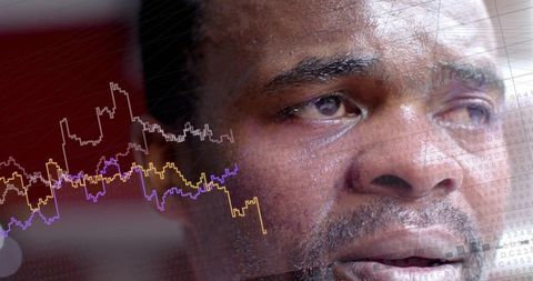Contemplative man analyzing financial market trends with data overlay on closeup portrait