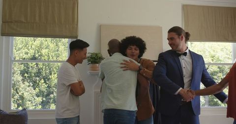 Friends preparing outfits for wedding celebration at home