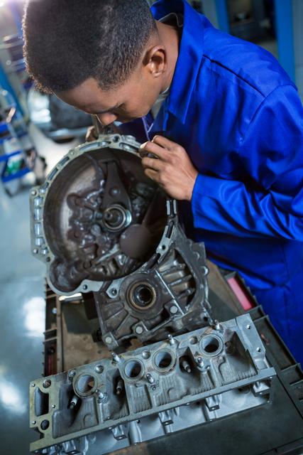 Mechanic repairing engine part - Download Free Stock Photos Pikwizard.com