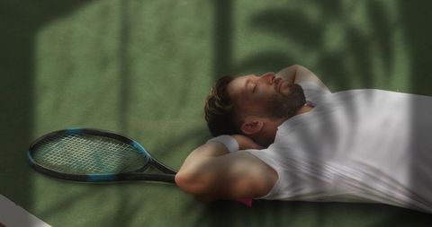 Tired Tennis Player Resting After Intense Match