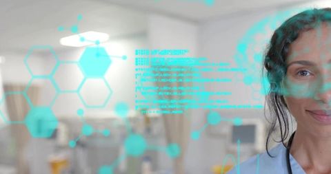 Smiling nurse standing in hospital ward wearing stethoscope with turquoise hologram interface