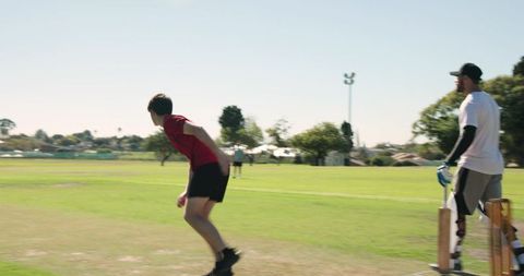 Cricket bowler appealing for wicket on suburban grassy pitch with batsman at crease