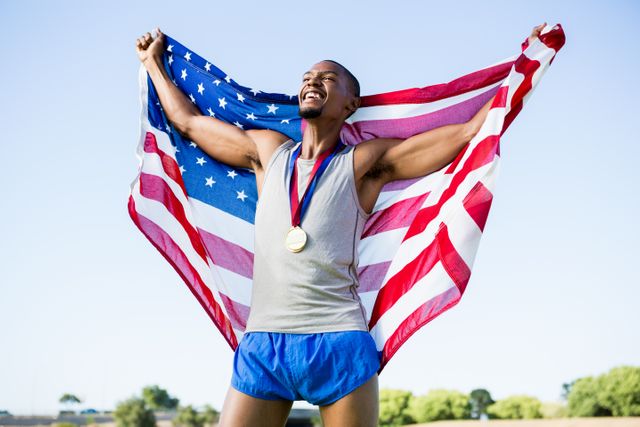 Athlete celebrating victory with American flag and gold medal, ideal for sports promotions, patriotic events, motivational posters, and fitness campaigns. Perfect for illustrating themes of success, achievement, and national pride.