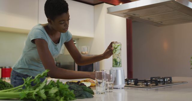 Young African American Woman Preparing Smoothie in Modern Kitchen - Download Free Stock Images Pikwizard.com