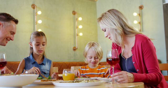 Happy Family Dining Together in Restaurant - Download Free Stock Images Pikwizard.com