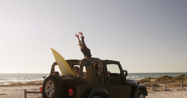 Happy Surfer Celebrating on a Jeep by the Beach at Sunset - Download Free Stock Images Pikwizard.com