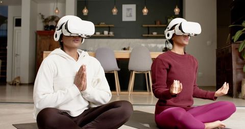 Women Exploring Virtual Reality Meditation on Yoga Mats at Home