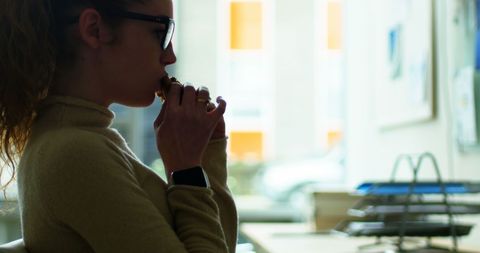 Female Executive Enjoys Quick Office Snack Break - Download Free Stock Images Pikwizard.com
