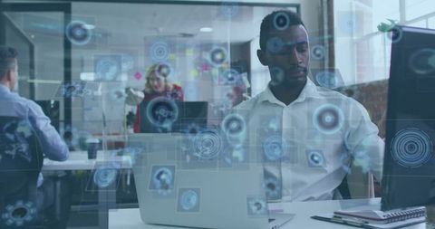 Focused Professional Working in Tech-Infused Office Environment