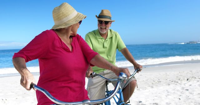 Happy Senior Couple Biking on Beach - Download Free Stock Images Pikwizard.com