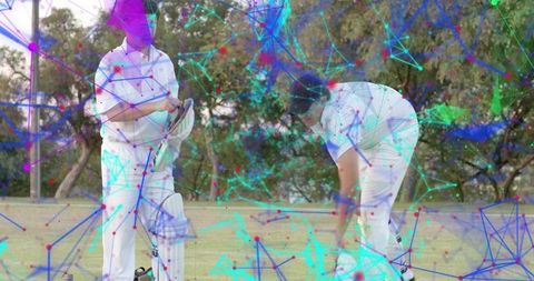 Cricket players practicing on grass with neon digital network overlay for sports tech