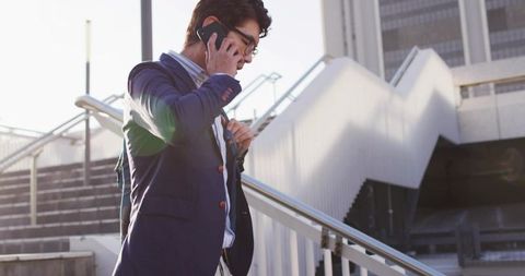 Asian Businessman Navigating Urban Landscape with Smartphone