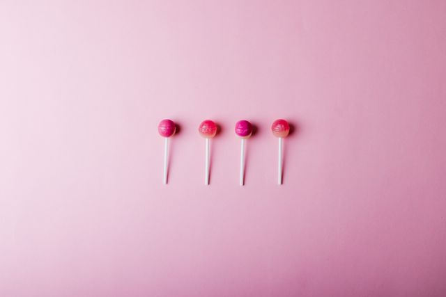 Four Pink Lollipops on Pink Background - Download Free Stock Photos Pikwizard.com
