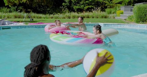 Young Friends Enjoying Water Fun in Backyard Pool