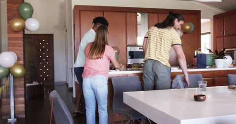 Friends Gathering in Kitchen Preparing for a Party