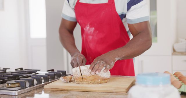 Man Wearing Red Apron Slicing Homemade Bread on Wooden Board - Download Free Stock Images Pikwizard.com