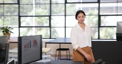 Confident Businesswoman Walking in Office Workspace