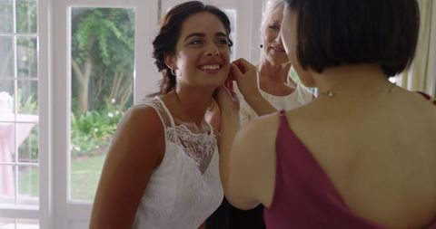 Bride Preparing with Bridesmaids Before Wedding Ceremony