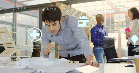 Multitasking entrepreneur analyzing financial data in modern office