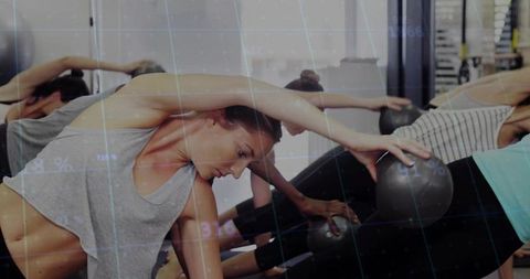 Women Stretching with Stability Balls in Fitness Class
