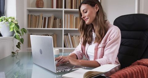 Woman Working on Laptop in Modern Minimalist Home Office