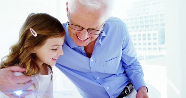 Grandfather and granddaughter sharing a joyful moment indoors - Download Free Stock Images Pikwizard.com