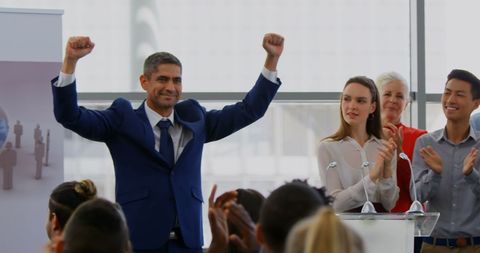 Confident Businessman Celebrating Success at Seminar - Download Free Stock Images Pikwizard.com