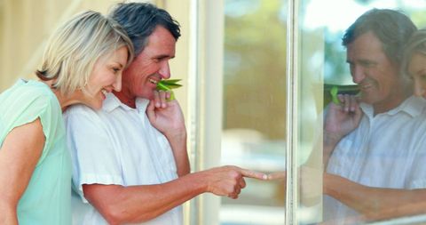 Cheerful Couple Window Shopping in Sunny City
