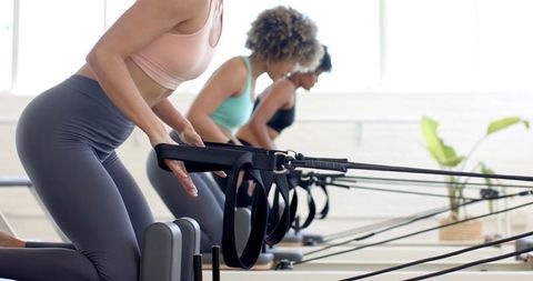 Diverse Women Engaging in Pilates Reformer Class for Fitness
