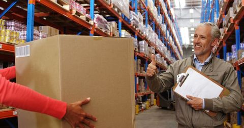 Senior Manager Supervising Warehouse Logistics with Thumb Up - Download Free Stock Images Pikwizard.com