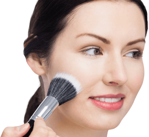 Woman applying makeup with brush on clear skin