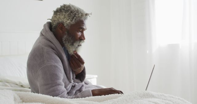 Senior Man Working on Laptop in Bed on a Sunny Morning - Download Free Stock Images Pikwizard.com