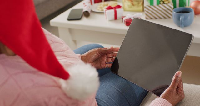 Senior Woman in Santa Hat Holding Tablet During Christmas - Download Free Stock Images Pikwizard.com