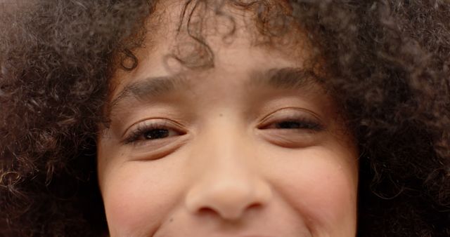 Close-Up of Happy Young Girl with Curly Hair Smiling - Download Free Stock Images Pikwizard.com