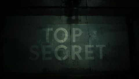 Top secret projection on grimy concrete bunker wall with industrial spotlight