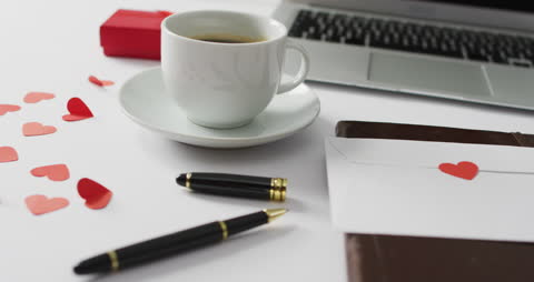 Romantic Workspace with Coffee and Red Hearts
