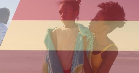 Family Enjoying Day at Sunny Beach with Towels and Warm Smiles